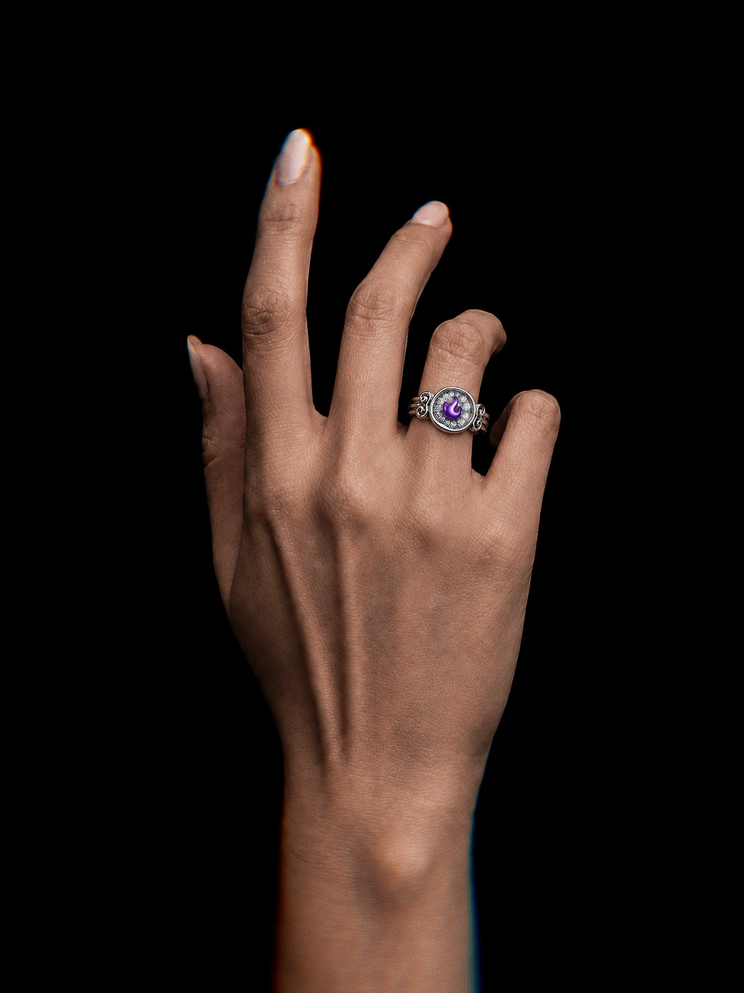 PurpleSea Flame Ring, sterling silver ring with a purple flame-shaped stone framed by ornate sculptural details, shown worn on a model's hand