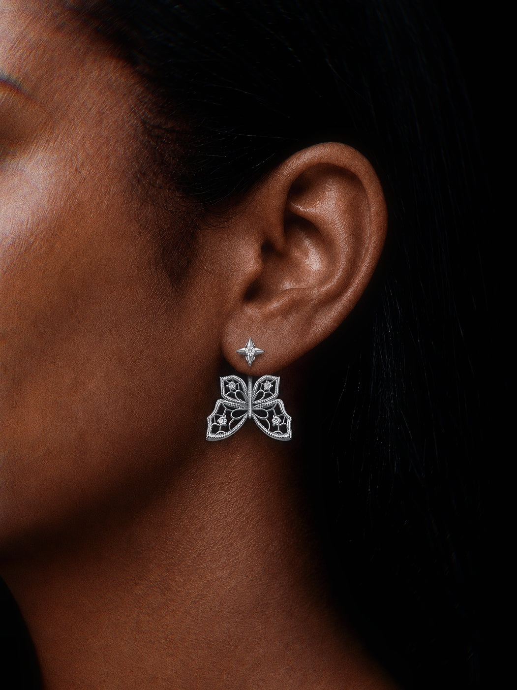 PurpleSea Butterfly Stud Earrings, sterling silver butterfly stud earrings with openwork wings and star-shaped posts, shown worn on a model's ear