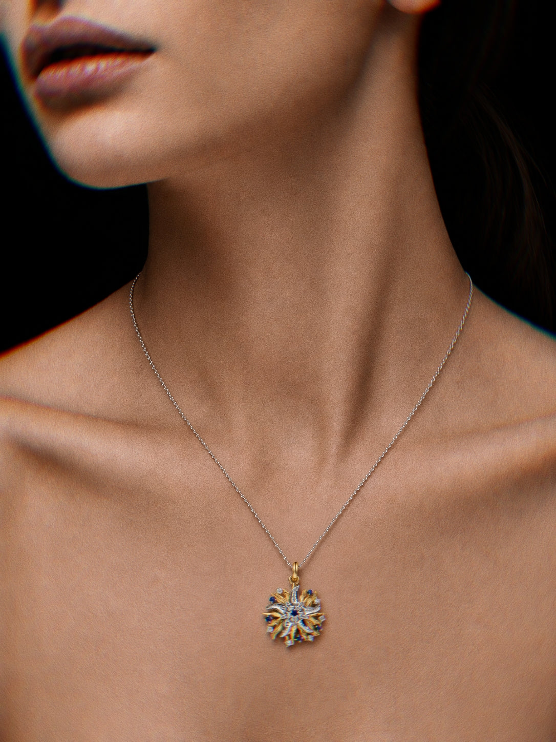 PurpleSea Reborn Starfish Pendant, two-tone starfish pendant with silver textured arms, gold accents and clear stone details, shown worn as a necklace on a model