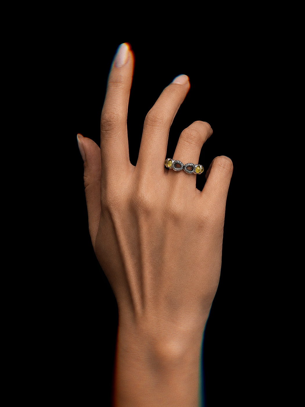 PurpleSea Infinity Ring, sterling silver open ring with repeating infinity motifs, clear stones and pale yellow accent stones, shown worn on a model's hand