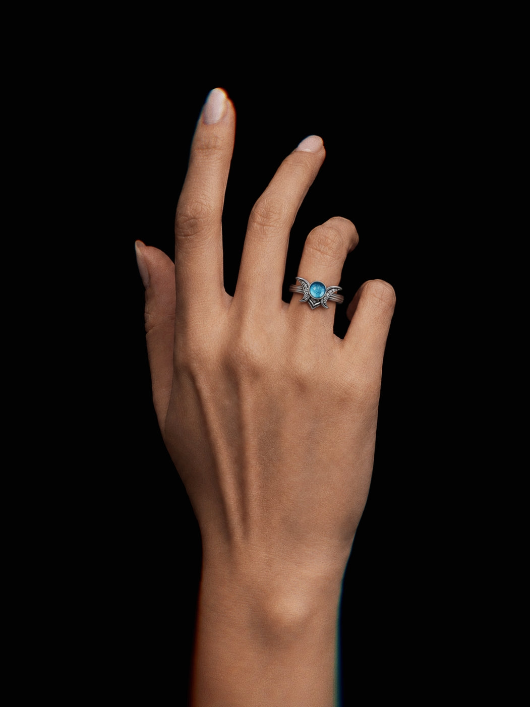 PurpleSea Moon Crown Ring, sterling silver ring with a luminous turquoise-blue round stone framed by crescent moon and crown-like details, shown worn on a model's hand