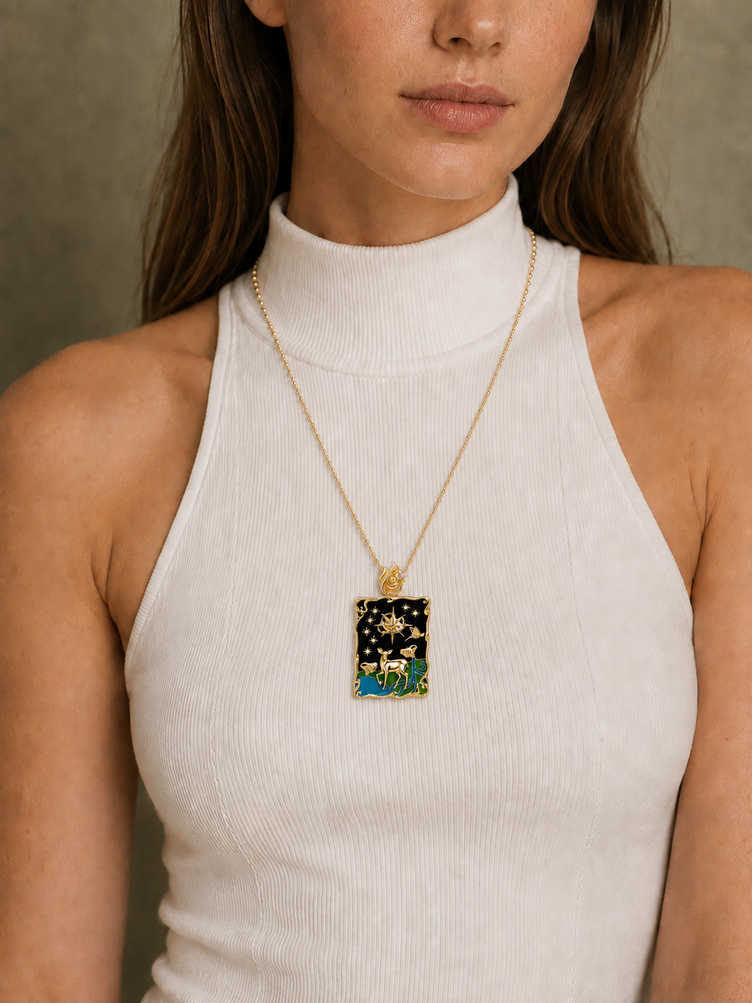 PurpleSea The Stars Pendant, tarot pendant with a gold-tone frame, black enamel, stars and a white deer motif, shown worn as a necklace on a model