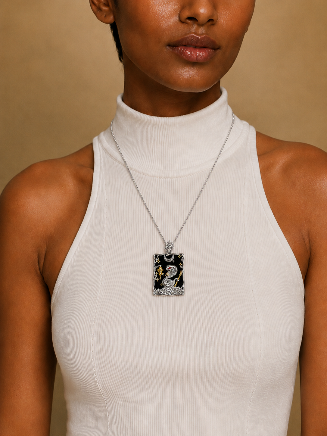 PurpleSea The Hermit Pendant, tarot pendant with silver-tone framing, black enamel, a coiled snake motif and small gold accents, shown worn as a necklace on a model